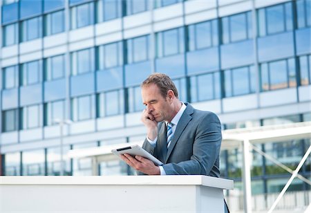 simsearch:600-06355235,k - Businessman using Tablet PC, Niederrad, Frankfurt, Germany Stock Photo - Premium Royalty-Free, Code: 600-06355243