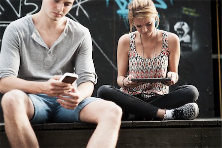 Couple using Smart Phone and Tablet PC, Mannheim, Baden-Wurttemberg, Germany Stock Photo - Premium Royalty-Free, Code: 600-06355266