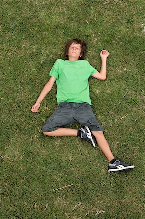 Boy Lying on Grass, Ile de Re, Poitou-Charentes, France Stock Photo - Premium Royalty-Free, Code: 600-06368385