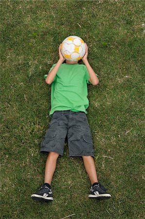 Boy Lying on Grass, Ile de Re, Poitou-Charentes, France Stock Photo - Premium Royalty-Free, Code: 600-06368386