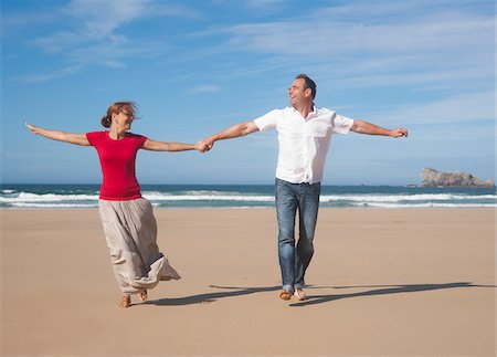 frolicking - Couple Holding Hands and Walking on the Beach, Camaret-sur-Mer, Crozon Peninsula, Finistere, Brittany, France Stock Photo - Premium Royalty-Free, Code: 600-06382817