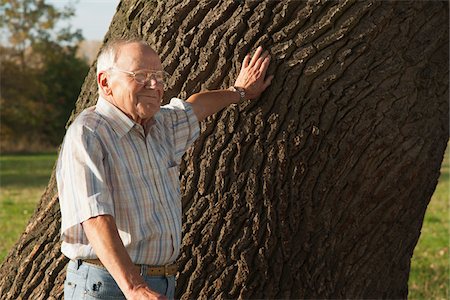Man Standing by Tree, Lampertheim, Hesse, Germany Stock Photo - Premium Royalty-Free, Code: 600-06397413