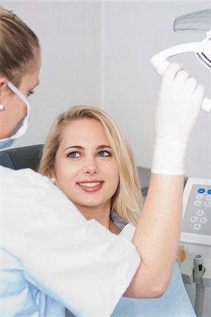 dentist and smile - Young Woman at Dentist's Office for Appointment, Germany Stock Photo - Premium Royalty-Free, Code: 600-06438878