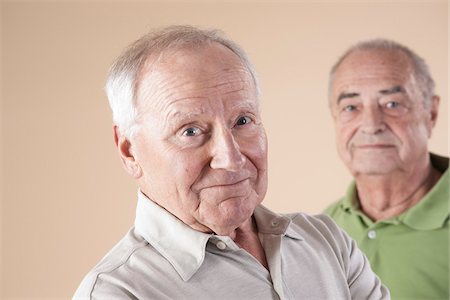 Portrait of Two Senior Men Looking at Camera, Studio Shot on Beige Background Stock Photo - Premium Royalty-Free, Code: 600-06438989