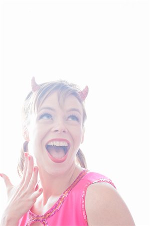 devil - Portrait of Woman Wearing Devil Horns Making Faces Stock Photo - Premium Royalty-Free, Code: 600-06431366