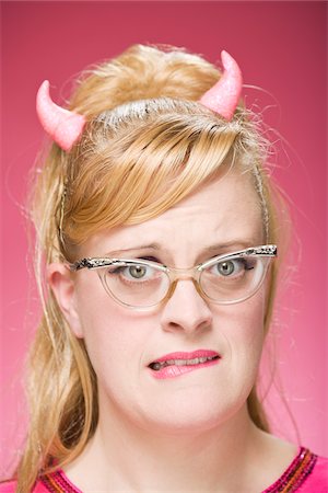 simsearch:700-03685912,k - Portrait of Woman Wearing Devil Horns and Vintage Eyeglasses Stock Photo - Premium Royalty-Free, Code: 600-06431396