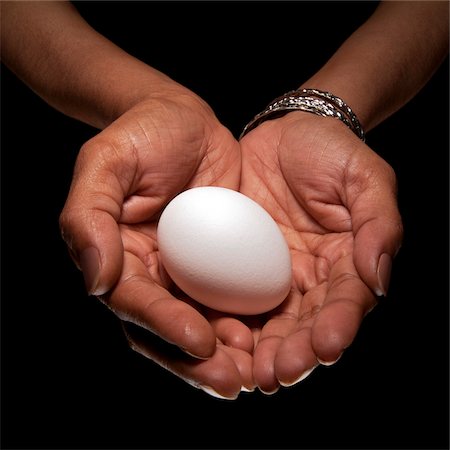 Close-up of Woman's Hands holding Egg, Studio Shot Stock Photo - Premium Royalty-Free, Code: 600-06452121