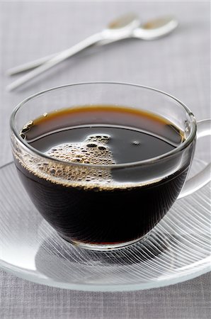 Close-up of Black Coffee in Glass Cup and Saucer on Grey Background, Studio Shot Stock Photo - Premium Royalty-Free, Code: 600-06486081