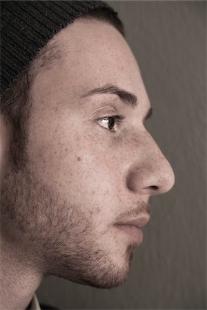 people and men only - Close-up, Side View of Young Man wearing Woolen Hat, Studio Shot Stock Photo - Premium Royalty-Free, Code: 600-06486248