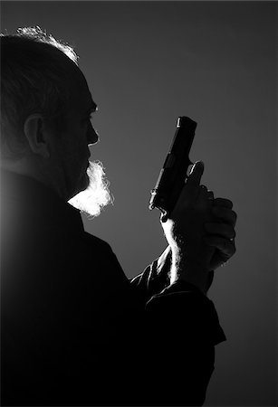 Backlit Man with Gun, Mannheim, Baden-Wurttemberg, Germany Stock Photo - Premium Royalty-Free, Code: 600-06486481