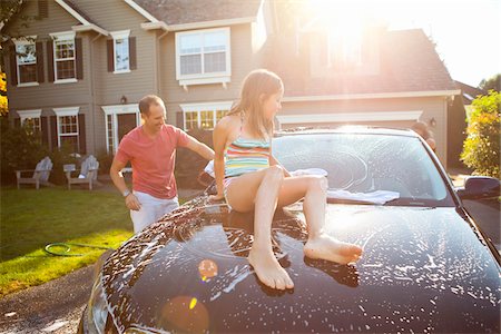 family house - Family washing their car in the driveway of their home on a sunny summer afternoon in Portland, Oregon, USA Stock Photo - Premium Royalty-Free, Code: 600-06531476