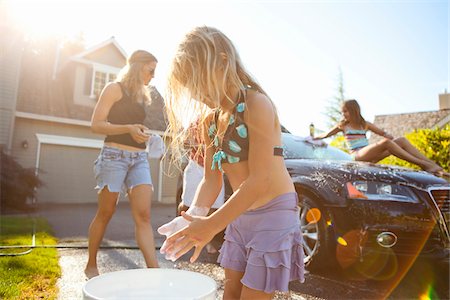 swimsuit family - Family washing their car in the driveway of their home on a sunny summer afternoon in Portland, Oregon, USA Stock Photo - Premium Royalty-Free, Code: 600-06531477