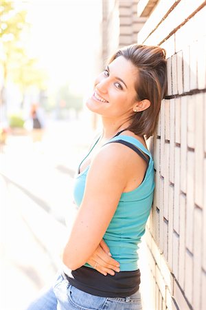 Portrait of Woman Outdoors leaning against Brick Wall, Portland, Oregon, USA Stock Photo - Premium Royalty-Free, Code: 600-06531565