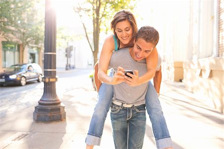 portland - Couple Outdoors, Man Piggybacking Woman, Portland, Oregon, USA Stock Photo - Premium Royalty-Free, Code: 600-06531562