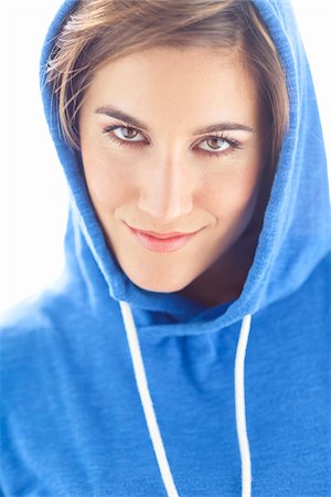 Head and Shoulders Portrait of Woman wearing Hoodie in Studio Stock Photo - Premium Royalty-Free, Code: 600-06531603