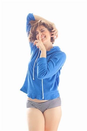 shhh - Portrait of Woman wearing Hoodie and Underwear in Studio Stock Photo - Premium Royalty-Free, Code: 600-06531612