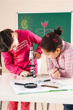 Girls Looking at Flower with Microscope in Classroom, Baden-Wurttemberg, Germany Stock Photo - Premium Royalty-Free, Code: 600-06548581