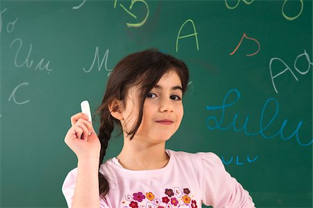 pigtail braids - Girl Answering Question at Blackboard in Classroom, Baden-Wurttemberg, Germany Stock Photo - Premium Royalty-Free, Code: 600-06548619
