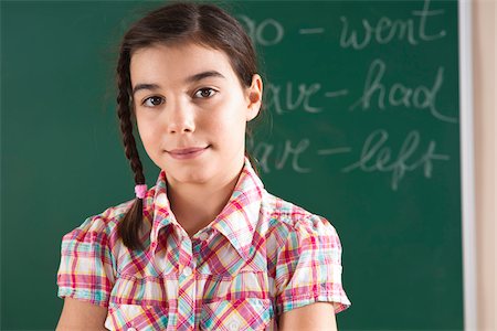 simsearch:600-06685174,k - Head and Shoulders Portrait of Girl in front of Chalkboard in Classroom Stock Photo - Premium Royalty-Free, Code: 600-06543523
