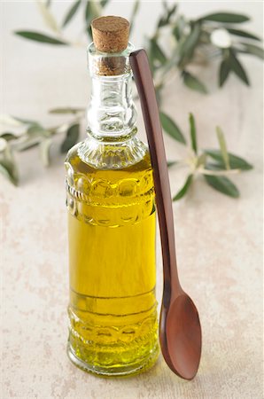 Bottle of Olive Oil with Wooden Spoon Stock Photo - Premium Royalty-Free, Code: 600-06553475