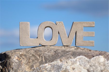 Close-up of Stone LOVE on Rock with Blue Sky, Frontignan, Herault, France Stock Photo - Premium Royalty-Free, Code: 600-06553505