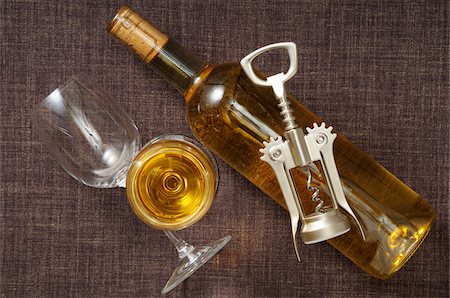 simsearch:600-06752237,k - Overhead View of Bottle of White Wine, Wine Glasses and Corkscrew Stock Photo - Premium Royalty-Free, Code: 600-06553512