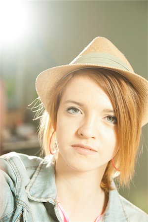 spotlight (beam of light) - Head and shoulders portrait of teenage girl wearing hat in studio. Stock Photo - Premium Royalty-Free, Code: 600-06553545