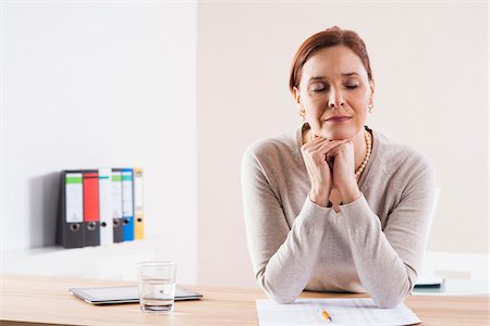 simsearch:600-06355235,k - Mature Woman Thinking in Office Stock Photo - Premium Royalty-Free, Code: 600-06645521