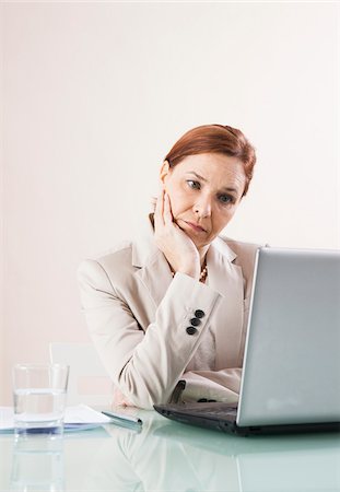simsearch:600-06355235,k - Mature Woman Working on Laptop in Office Stock Photo - Premium Royalty-Free, Code: 600-06645551