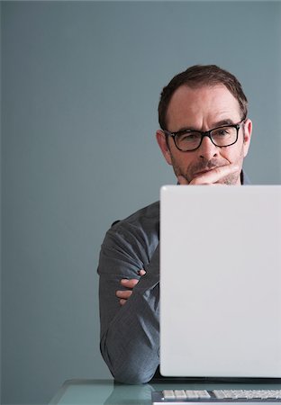 Businessman Using Computer in Studio Stock Photo - Premium Royalty-Free, Code: 600-06645881