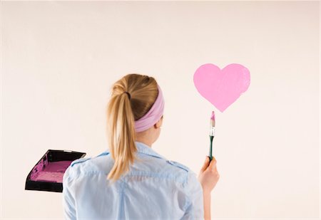 simsearch:600-06671795,k - Studio Shot of Young Woman Painting Heart on Wall Stock Photo - Premium Royalty-Free, Code: 600-06671774