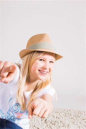 simsearch:600-06685174,k - Portrait of Girl wearing Hat and Pointing at Camera in Studio Stock Photo - Premium Royalty-Free, Code: 600-06685178