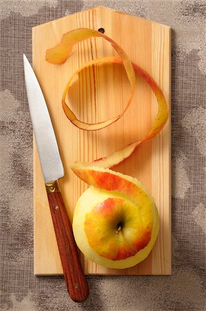 simsearch:600-06752237,k - Overhead View of Apple with Skin Peeled on Cutting Board with Knife, Studio Shot Stock Photo - Premium Royalty-Free, Code: 600-06702110