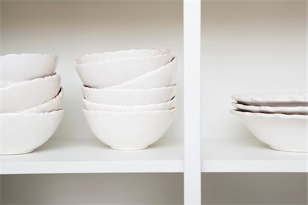 Stacked Bowls in Kitchen Cupboard Stock Photo - Premium Royalty-Free, Code: 600-06752171