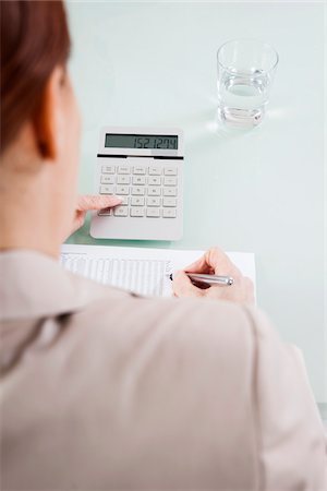 Over the Shoulder View of Mature Woman Working on Budget in Office Foto de stock - Sin royalties Premium, Código: 600-06787017