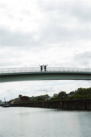 simsearch:600-06773367,k - Silhouette of mature businessmen standing on bridge with arms in air, Mannheim, Germany Stock Photo - Premium Royalty-Free, Code: 600-06782228