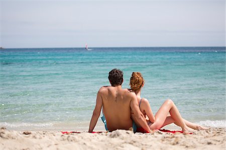 european bathing suits men - Couple Relaxing at Beach, Sardinia, Italy Stock Photo - Premium Royalty-Free, Code: 600-06819395