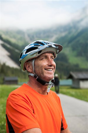 Portrait of Mature Man wearing Bike Helmet, Vilsalpsee, Tannheim Valley, Tyrol, Austria Fotografie stock - Premium Royalty-Free, Codice: 600-06819400