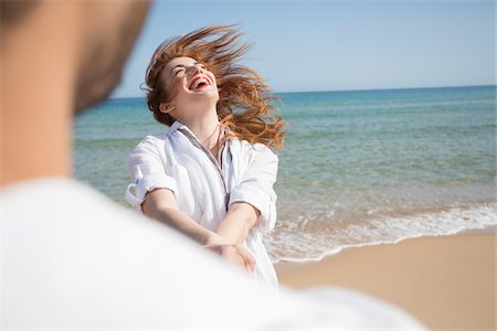 surf couple - Couple Playing on Beach, Sardinia, Italy Stock Photo - Premium Royalty-Free, Code: 600-06819435