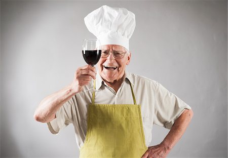 elderly sign - Senior Man with Red Wine wearing Apron and Chef's Hat, Studio Shot Stock Photo - Premium Royalty-Free, Code: 600-06819432