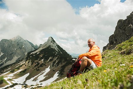 Mature man sitting on grass, hiking in mountains, Tannheim Valley, Austria Fotografie stock - Premium Royalty-Free, Codice: 600-06826370