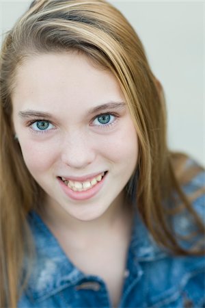 Close-up Portrait of pre-teen girl smiling and looking at camera Stock Photo - Premium Royalty-Free, Code: 600-06847440
