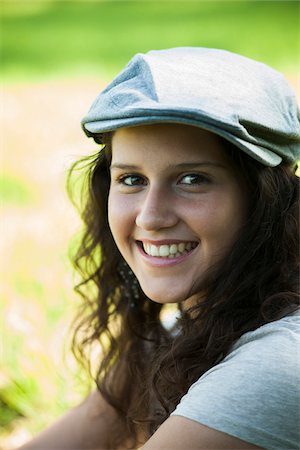 simsearch:600-06899843,k - Close-up portrait of teenaged girl wearing cap outdoors, smiling and looking at camera, Germany Stock Photo - Premium Royalty-Free, Code: 600-06899826