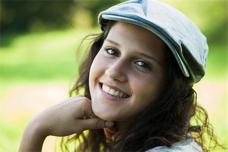simsearch:600-06899824,k - Close-up portrait of teenaged girl wearing cap outdoors, smiling and looking at camera, Germany Stock Photo - Premium Royalty-Free, Code: 600-06899827