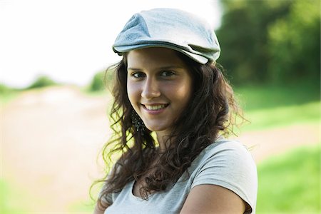 simsearch:600-06899824,k - Close-up portrait of teenaged girl wearing cap outdoors, smiling and looking at camera, Germany Stock Photo - Premium Royalty-Free, Code: 600-06899847