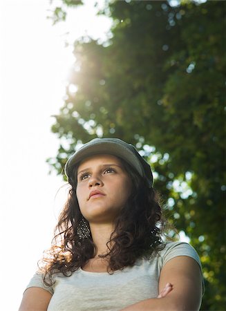 simsearch:600-07567389,k - Close-up portrait of teenaged girl wearing cap outdoors, looking into the distance, Germany Stock Photo - Premium Royalty-Free, Code: 600-06899854