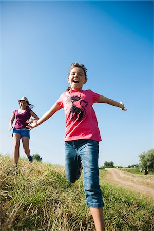 preteen open mouth - Girls running in field, Germany Stock Photo - Premium Royalty-Free, Code: 600-06899867