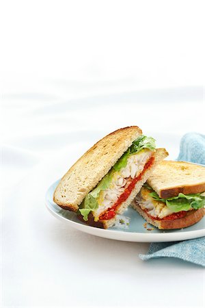 plated food - Almond Coated Fish Sandwich on Toasted Rye Bread, Cut in Half, Studio Shot Stock Photo - Premium Royalty-Free, Code: 600-06892671