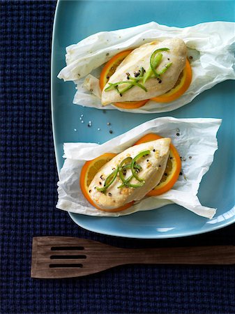 Parchment Paper Packets of Steamed Chicken Breast with Oranges, Black Pepper and Sliced Green Pepper, Studio Shot Stock Photo - Premium Royalty-Free, Code: 600-06892682