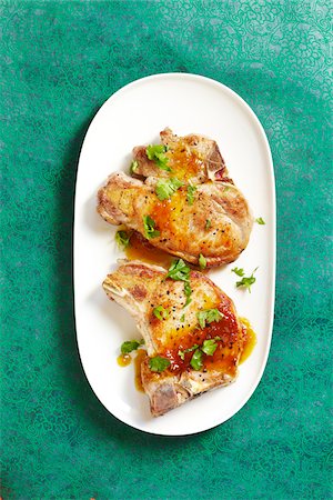 simsearch:600-07311268,k - Overhead View of Pork Chops with Fruit Sauce and Cilantro, Studio Shot Stock Photo - Premium Royalty-Free, Code: 600-06934983